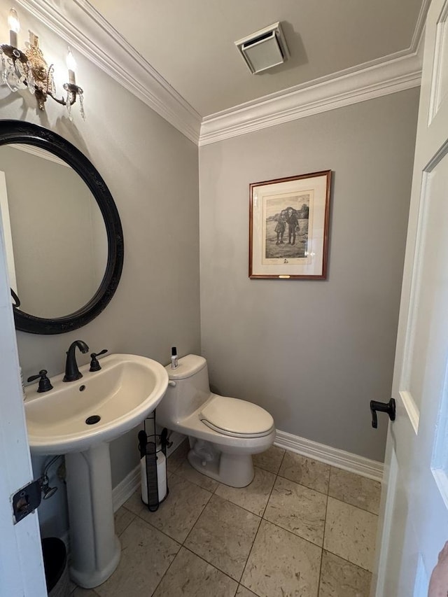 bathroom with crown molding, toilet, baseboards, and visible vents