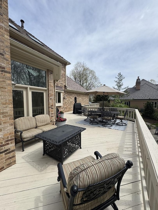 wooden terrace with outdoor dining area
