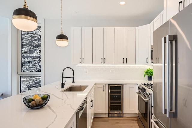 1462 W Winnemac Ave Unit 2, Chicago, IL 60640 - kitchen featuring a sink, stainless steel appliances, light stone counters, beverage cooler, and white cabinets