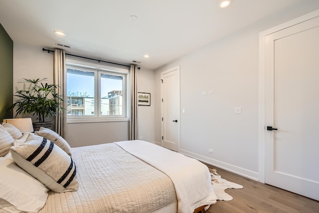 1462 W Winnemac Ave Unit 2, Chicago, IL 60640 - bedroom featuring recessed lighting, baseboards, visible vents, and wood finished floors