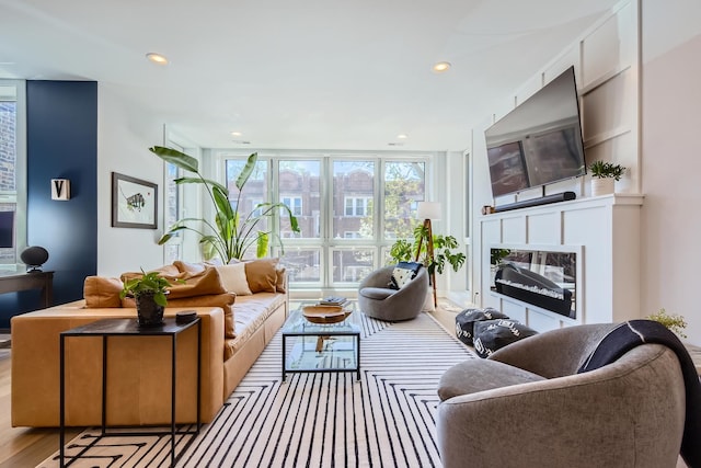 1462 W Winnemac Ave Unit 2, Chicago, IL 60640 - living room featuring a glass covered fireplace, recessed lighting, and wood finished floors