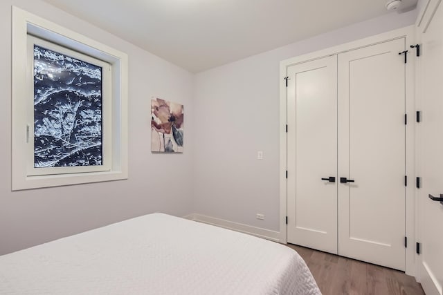 1462 W Winnemac Ave Unit 2, Chicago, IL 60640 - bedroom featuring a closet, baseboards, and light wood-style floors