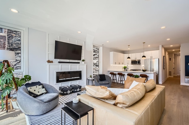1462 W Winnemac Ave Unit 2, Chicago, IL 60640 - living room with baseboards, light wood-style floors, a glass covered fireplace, and recessed lighting