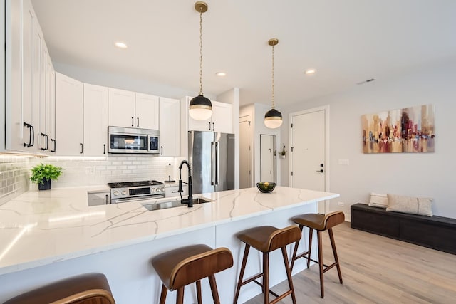 1462 W Winnemac Ave Unit 2, Chicago, IL 60640 - kitchen featuring a peninsula, appliances with stainless steel finishes, a sink, and tasteful backsplash
