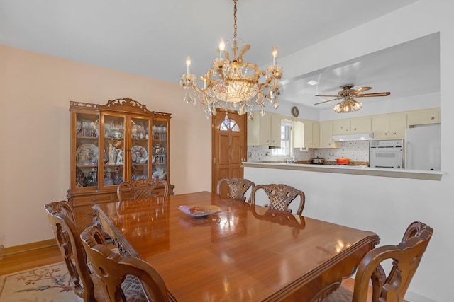 2054 Birch St, Des Plaines, IL 60018 - dining room with ceiling fan, a chandelier, light wood-style flooring, and baseboards