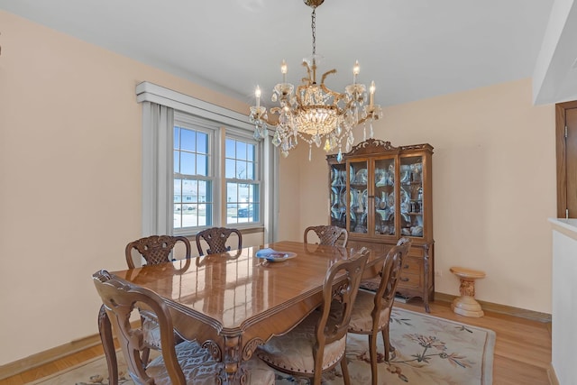 2054 Birch St, Des Plaines, IL 60018 - dining space featuring a chandelier, baseboards, and light wood-type flooring