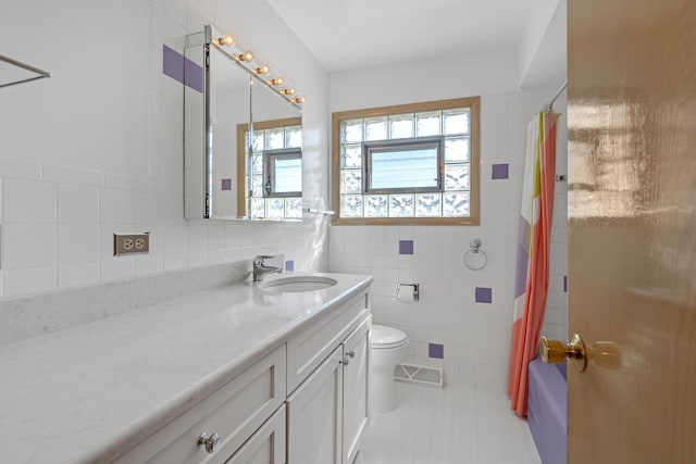2054 Birch St, Des Plaines, IL 60018 - full bathroom with vanity, tile walls, toilet, shower / tub combo with curtain, and tile patterned flooring