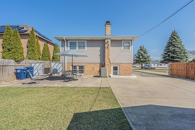 2054 Birch St, Des Plaines, IL 60018 - back of property with a chimney, a patio area, central AC unit, and brick siding