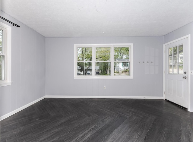 interior space with baseboards and plenty of natural light