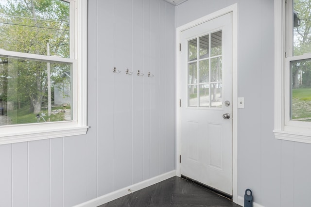 doorway to outside with a healthy amount of sunlight and baseboards
