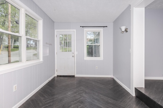 doorway to outside with baseboards