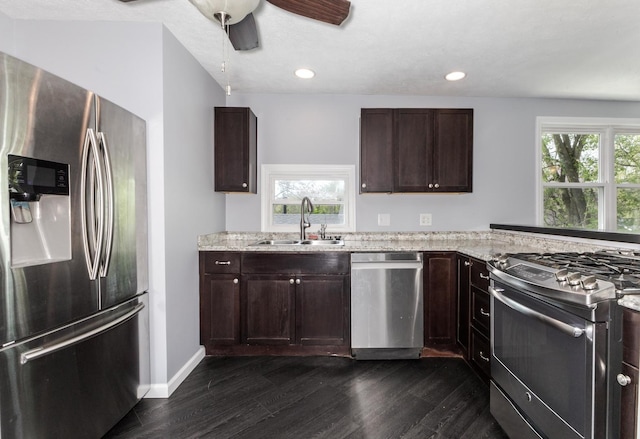 kitchen with a sink, dark wood-style floors, a wealth of natural light, and stainless steel appliances