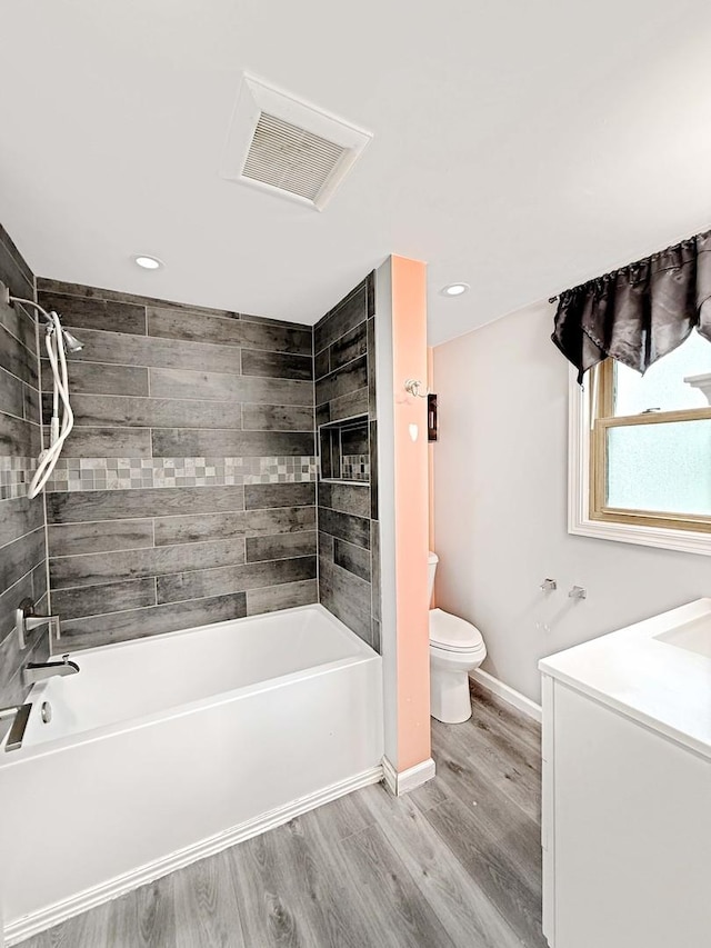 full bathroom featuring shower / bathing tub combination, baseboards, wood finished floors, and toilet