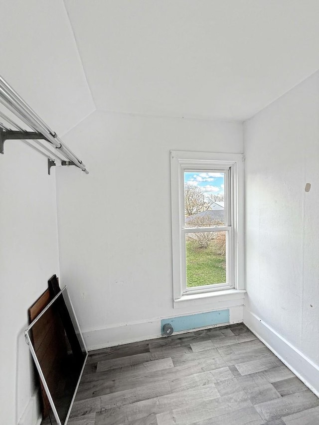 interior space featuring light wood finished floors and baseboards