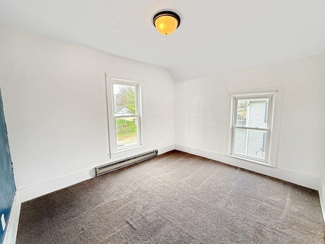 carpeted empty room with a baseboard heating unit, lofted ceiling, a healthy amount of sunlight, and baseboards