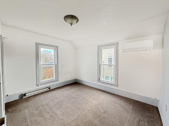 spare room featuring baseboard heating, lofted ceiling, carpet floors, and a wall unit AC