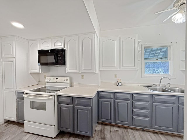 kitchen featuring white cabinets, a sink, electric range, gray cabinetry, and black microwave