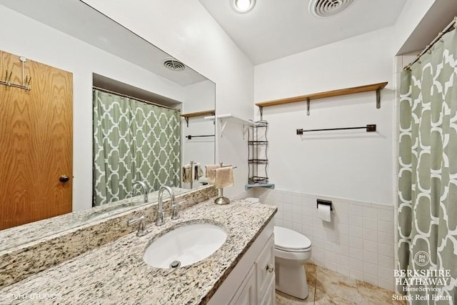 1502 Plymouth Pl Unit 1W, Glenview, IL 60025 - bathroom featuring toilet, vanity, visible vents, and tile walls