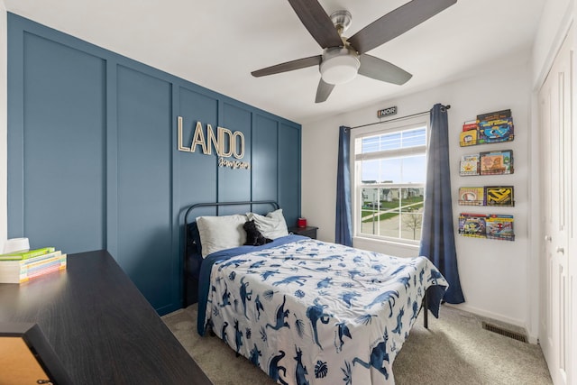 bedroom with baseboards, a ceiling fan, visible vents, and carpet floors