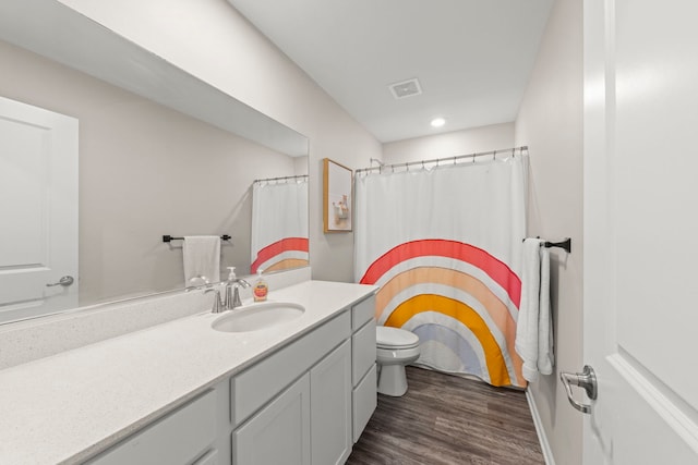 bathroom with recessed lighting, wood finished floors, visible vents, toilet, and vanity