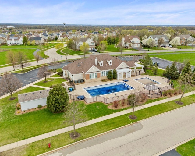 community pool with a yard, a residential view, and a fenced backyard