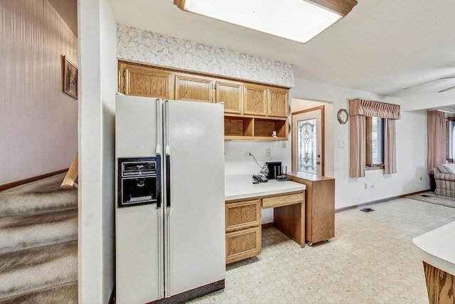 14506 Mallard Dr, Homer Glen, IL 60491 - kitchen with built in desk, light countertops, open shelves, baseboards, and white refrigerator with ice dispenser