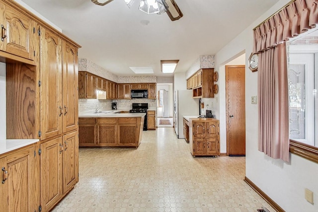14506 Mallard Dr, Homer Glen, IL 60491 - kitchen with brown cabinets, light countertops, a ceiling fan, baseboards, and black appliances