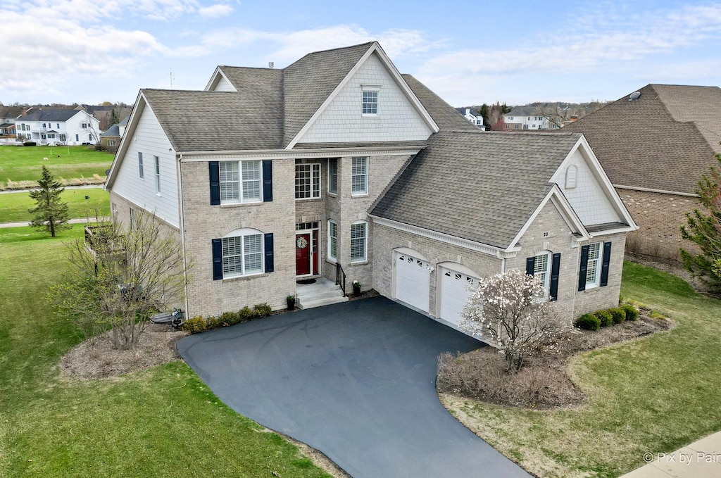 20 Championship Pkwy, Hawthorn Woods, IL 60047 - traditional home with roof with shingles, driveway, a front yard, and a garage
