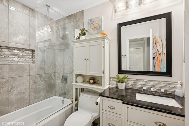 full bath with vanity, a combined bath / shower with rainfall shower, toilet, and tasteful backsplash