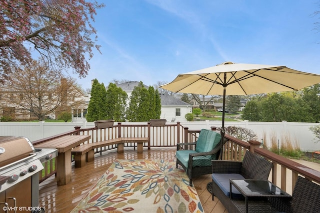 wooden terrace featuring area for grilling, fence, and outdoor lounge area