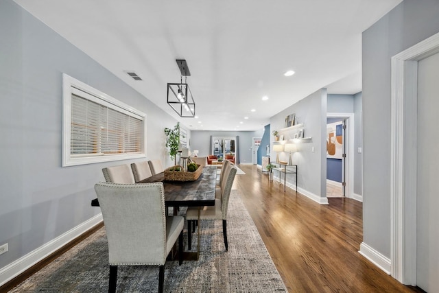 dining room featuring dark wood-type flooring, baseboards, visible vents, and recessed lighting
