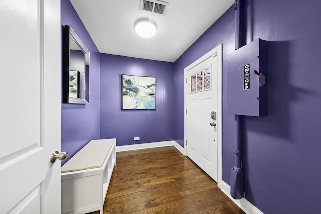entryway with visible vents, baseboards, and wood finished floors