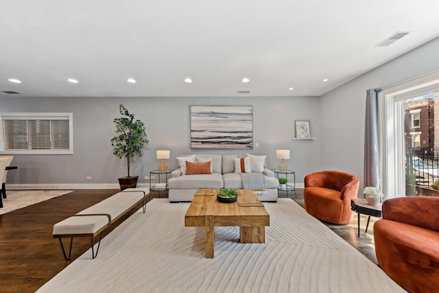 living area featuring recessed lighting, visible vents, baseboards, and wood finished floors
