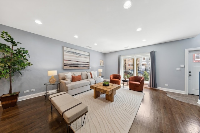 living room featuring dark wood-type flooring, baseboards, visible vents, and recessed lighting