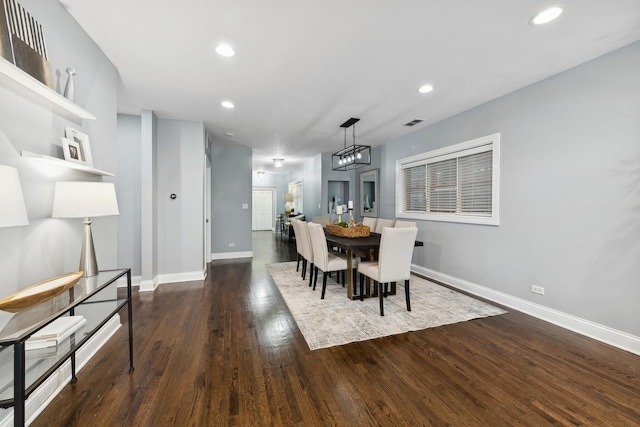 dining room featuring a notable chandelier, baseboards, recessed lighting, visible vents, and wood finished floors