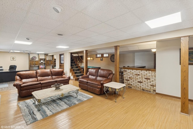 12524 Grandview Dr, Huntley, IL 60142 - living area with wood finished floors, a drop ceiling, stairs, and baseboards