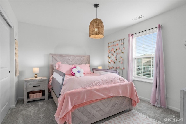bedroom with baseboards, visible vents, and carpet