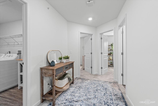 corridor featuring washing machine and dryer, baseboards, carpet floors, and recessed lighting