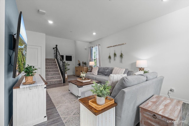 living area featuring wood finished floors, recessed lighting, and stairs