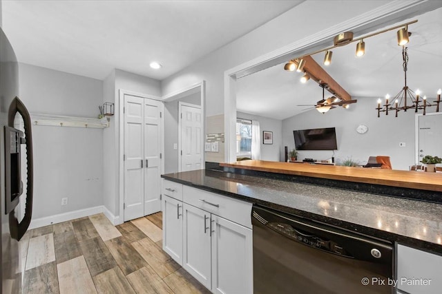 kitchen featuring dishwasher, pendant lighting, light wood-style flooring, white cabinetry, and ceiling fan with notable chandelier
