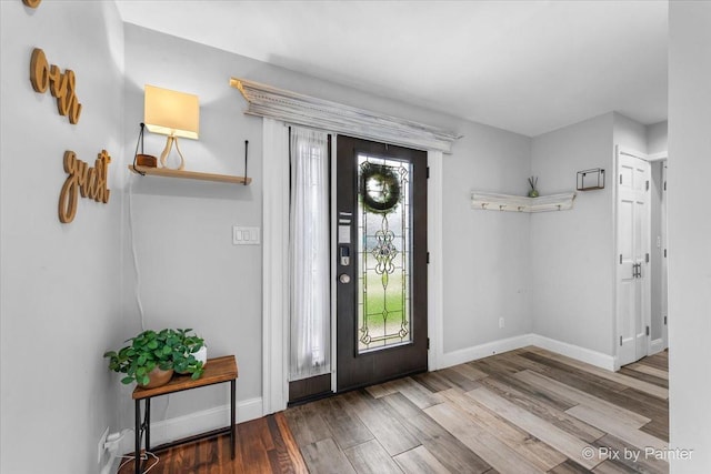 entrance foyer featuring baseboards and wood finished floors