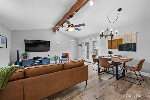 living area featuring lofted ceiling with beams, french doors, wood finished floors, and ceiling fan with notable chandelier