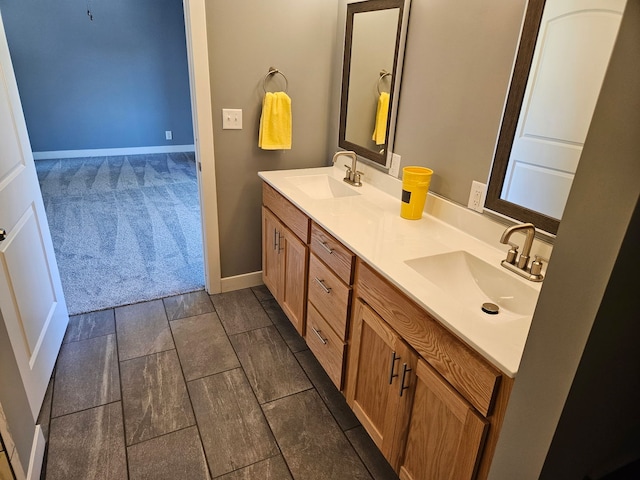 bathroom featuring double vanity and baseboards