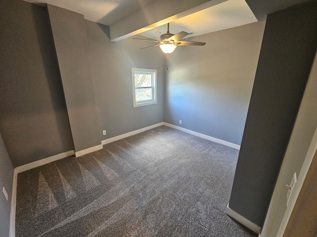 unfurnished room with a ceiling fan, dark colored carpet, beam ceiling, and baseboards