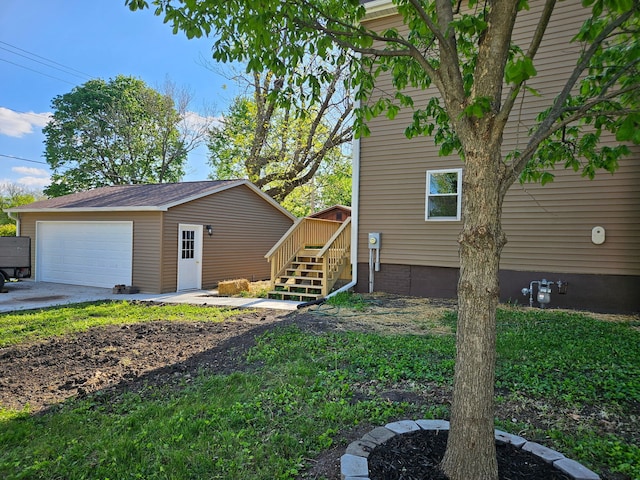 view of home's exterior featuring an outbuilding, stairs, and a garage