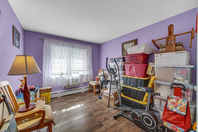 interior space with a baseboard radiator and wood finished floors