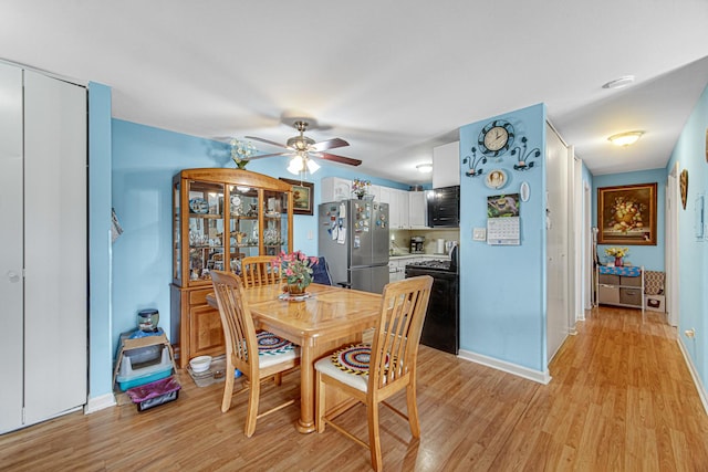 dining space with light wood-style flooring, baseboards, and a ceiling fan