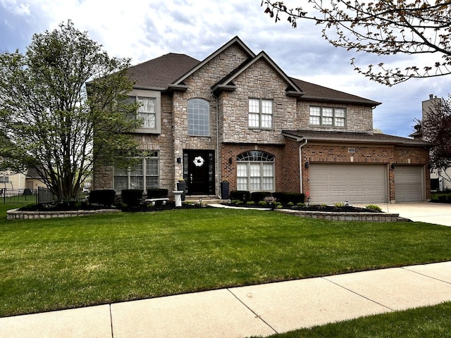 view of front of property featuring stone siding, an attached garage, driveway, and a front yard