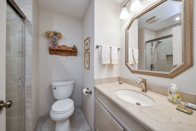 bathroom featuring vanity, visible vents, a shower stall, and toilet