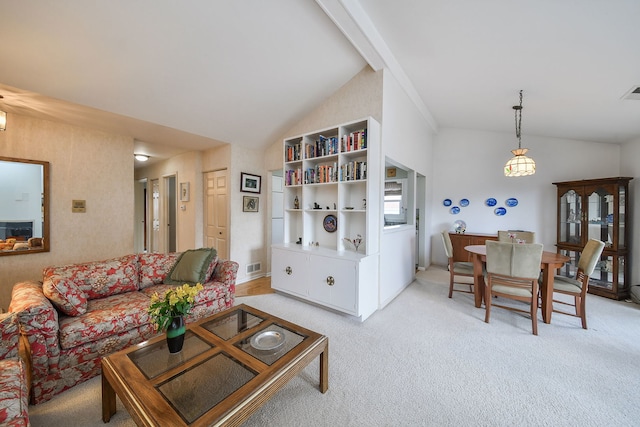 living room featuring high vaulted ceiling, light carpet, and visible vents